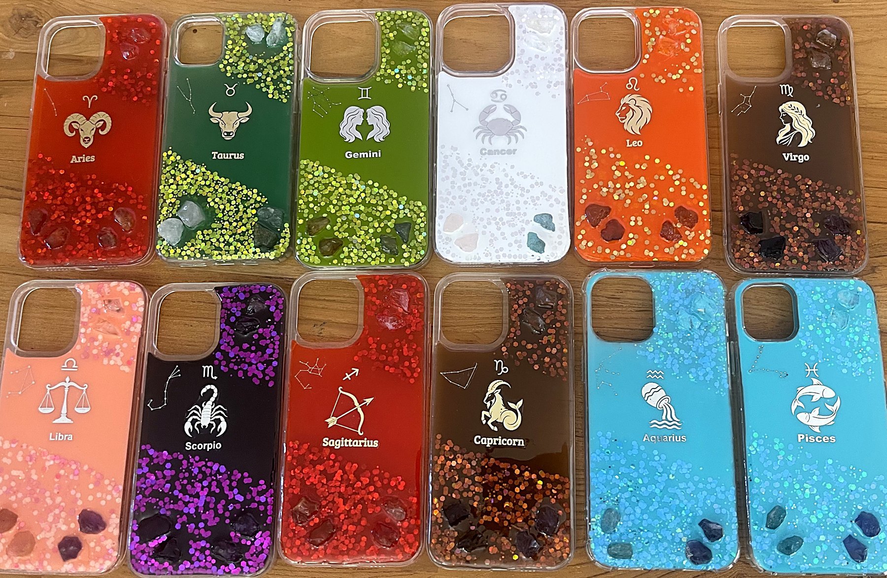 All twelve YADi zodiac crystal cases on wood